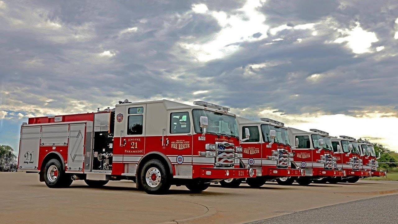 Row of fire trucks lined up on a street for emergency response readiness.